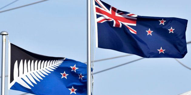The current New Zealand flag (R) flutters next to the alternative flag (L) in Wellington on March 4, 2016. New Zealanders began voting on March 3, on whether to adopt a new flag, in a referendum Prime Minister John Key has called a once-in-a-generation chance to ditch Britain's Union Jack from the national banner. AFP PHOTO / MARTY MELVILLE / AFP / Marty Melville (Photo credit should read MARTY MELVILLE/AFP/Getty Images)