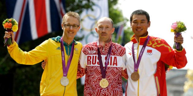 Gold-medallist Sergey Kirdyapkin of Russia, center, stands with silver-medallist Jared Tallent of Australia, left, and bronze-medallist Si Tianfeng of China after the men's 50-kilometer race walk competition at the 2012 Summer Olympics, Saturday, Aug. 11, 2012, in London. (AP Photo/Mike Groll)