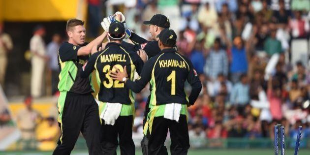 Australia's James Faulkner (L) celebrates with teammates after bowling out Pakistan's Sharjeel Khan during the World T20 cricket tournament match between Australia and Pakistan at The Punjab Cricket Stadium Association Stadium in Mohali on March 25, 2016. / AFP / MONEY SHARMA (Photo credit should read MONEY SHARMA/AFP/Getty Images)