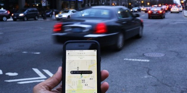 An UBER application is shown as cars drive by in Washington, DC on March 25, 2015. Uber said it was ramping up safety in response to rape allegations against a driver in India and growing concerns about background checks for operators of the popular ride-sharing service. In other cities where Uber operates, critics had complained that a lack of licensing and background checks of drivers could imperil those who use the service. AFP PHOTO/ ANDREW CABALLERO-REYNOLDS (Photo credit should read Andrew Caballero-Reynolds/AFP/Getty Images)