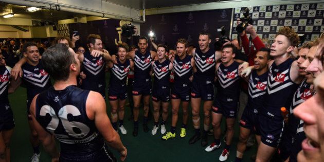 PERTH, AUSTRALIA - AUGUST 30: Ed Langdon of the Fremantle Dockers is showered with sports drink at the team song during the 2015 AFL round 22 match between the Fremantle Dockers and the Melbourne Demons at Domain Stadium, Perth, Australia on August 30, 2015. (Photo by Daniel Carson/AFL Media/Getty Images)