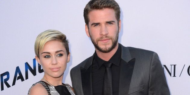 Actor Liam Hemsworth, right, and singer Miley Cyrus arrive at the US premiere of