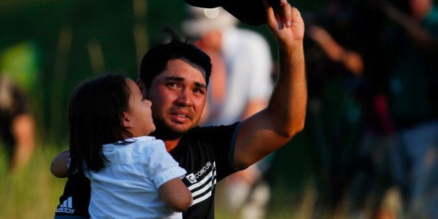 SHEBOYGAN, WI - AUGUST 16: Jason Day of Australia walks off the 18th green with his son Dash after winning the 2015 PGA Championship with a score of 20-under par at Whistling Straits on August 16, 2015 in Sheboygan, Wisconsin. (Photo by Kevin C. Cox/Getty Images)