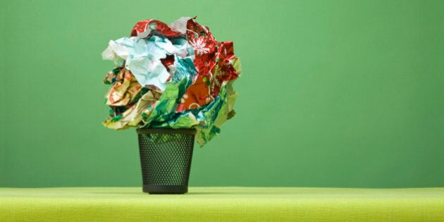 Ball of Christmas wrapping paper in in mini trashcan