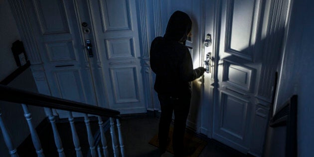 BERLIN, GERMANY - JUNE 27: Posed scene of a man breaking into an apartment on June 27, 2014, in Berlin, Germany. The photo symbolizes the increasing risk of burglary in Germany. (Photo by Thomas Trutschel/Photothek via Getty Images)