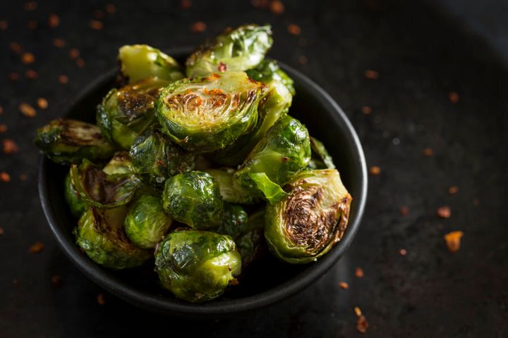Try roasting brussel sprouts with chilli flakes, olive oil, salt and pepper. Delish.