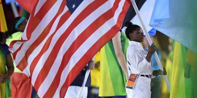 USA's flag-bearer Simone Biles holds her country's national flag during the closing ceremony of the Rio 2016 Olympic Games at the Maracana stadium in Rio de Janeiro on August 21, 2016. / AFP / Leon NEAL (Photo credit should read LEON NEAL/AFP/Getty Images)