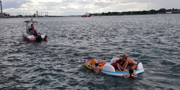 A Canadian Coast Guard ship tows floatation devices used by U.S. partiers to the Canadian side of the St. Clair River between Michigan and Ontario on August 21, 2016. About 1,500 Americans ended up in Canada after getting hit by strong wind and rain. Canadian Coast Guard/Handout via Reuters ATTENTION EDITORS - THIS IMAGE WAS PROVIDED BY A THIRD PARTY. EDITORIAL USE ONLY