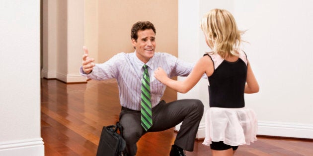 Businessman receiving a warm welcome from his daughter