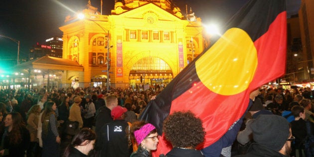 MELBOURNE, AUSTRALIA - JUNE 26: Protestors take over the intersection of Flinders and Swanston Street on June 26, 2015 in Melbourne, Australia. Thousands of protesters gathered in Melbourne today to rally against the Western Australian government plan to close 150 aboriginal communities. Rallies will be held in several capital cities over the next few days. (Photo by Quinn Rooney/Getty Images)