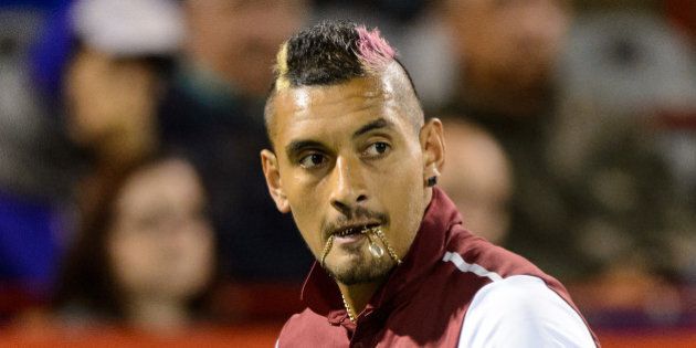 MONTREAL, ON - AUGUST 12: Nick Kyrgios of Australia looks on as he bites onto his chain against Stan Wawrinka of Switzerland during day three of the Rogers Cup at Uniprix Stadium on August 12, 2015 in Montreal, Quebec, Canada. (Photo by Minas Panagiotakis/Getty Images)
