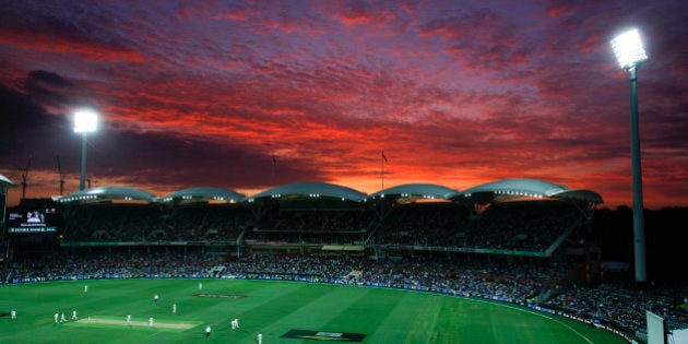 Lights illuminate the Adelaide Oval as the sun sets during the first night session of the cricket test between Australia and New Zealand in Adelaide, Friday, Nov. 27, 2015. This match is the sport's first ever day-night test and the use of the âexperimentalâ pink leather ball replacing the standard-issue red for the first time in a format that dates back to the 1870s. (AP Photo/Rick Rycroft)