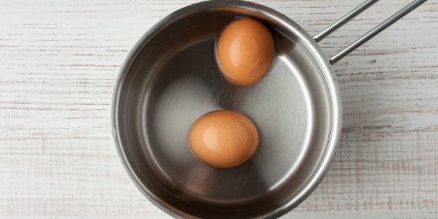 Close-up of eggs boiling on gas burner