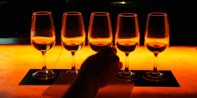 CHENGDU, CHINA - MAY 12: (CHINA OUT) A Chinese person takes a glass of whisky at the Johnnie Walker Black Label Tasting Party on May 12, 2005 in Chengdu of Sichuan Province, China. Johnnie Walker is expanding its business in China's booming whisky market. (Photo by China Photos/Getty Images)