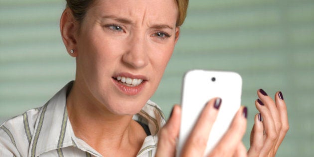 Unhappy woman on smart phone