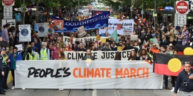 People march along a road during a rally calling for action on climate change in Melbourne on November 27, 2015. From school children to the elderly, thousands rallied in the Australian city of Melbourne on November 27 to demand action on climate change ahead of crunch talks in Paris designed to stop Earth from overheating. AFP PHOTO / Paul Crock / AFP / PAUL CROCK (Photo credit should read PAUL CROCK/AFP/Getty Images)