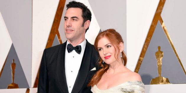 Sacha Baron Cohen, left, and Isla Fisher arrive at the Oscars on Sunday, Feb. 28, 2016, at the Dolby Theatre in Los Angeles. (Photo by Dan Steinberg/Invision/AP)