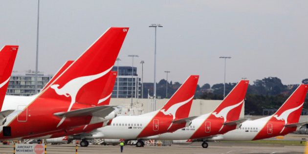 The tails of Qantas planes are lined up at Sydney Airport in Sydney, Sunday, Oct. 30, 2011. Qantas Airways grounded all of its aircraft around the world indefinitely Saturday due to ongoing strikes by its workers. (AP Photo/Rick Rycroft)