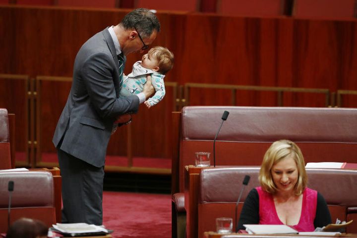 Senator Richard Di Natale plays with Larissa Waters' baby Alia in the Senate.
