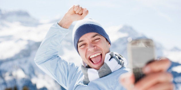 Man taking self-portrait with cell phone