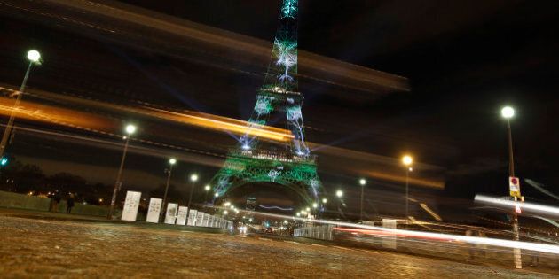An artwork entitled 'One Heart One Tree' by artist Naziha Mestaoui is displayed on the Eiffel tower as part of the COP21, United Nations Climate Change Conference, Monday, Nov. 30, 2015. (AP Photo/Laurent Cipriani)