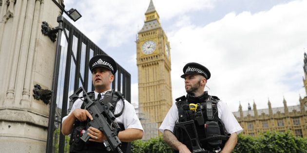 Armed police patrol by the Houses of Parliament on June 16, 2017.London police today arrested a man at the fence surrounding the British parliament on suspicion of carrying a knife, which comes nearly three months after an Islamist terror attack in the same area. / AFP PHOTO / Tolga AKMEN (Photo credit should read TOLGA AKMEN/AFP/Getty Images)