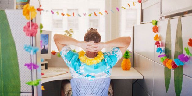 Man Relaxing in Hawaiian Decorated Cubicle