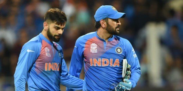 India's Virat Kohli(L)and captain Mahendra Singh Dhoni look on after defeat in the World T20 cricket tournament second semi-final match between India and West Indies at The Wankhede Stadium in Mumbai on March 31, 2016. / AFP / INDRANIL MUKHERJEE (Photo credit should read INDRANIL MUKHERJEE/AFP/Getty Images)