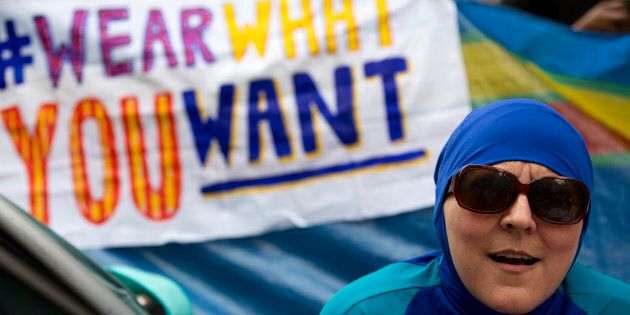 A woman wearing a 'Burkini' joins a protest outside the French Embassy in London on August 25, 2016, during a 'Wear what you want beach party' to demonstrate against the ban on Burkinis on French beaches and to show solidarity with Muslim women.French Interior Minister Bernard Cazeneuve warned Wednesday against stigmatising Muslims, as a furore over the banning of burkinis grew with the emergence of pictures showing police surrounding a veiled woman on a beach. Dozens of French towns and villag