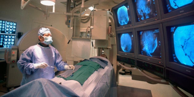 Doctor performing brain surgery on patient