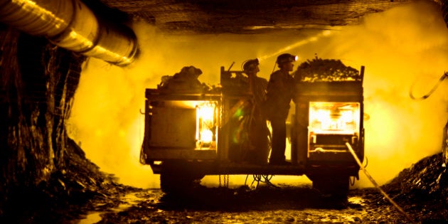 Two coal miners in mine shaft