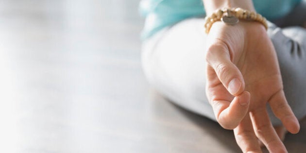 Close up of woman practicing mudra meditation