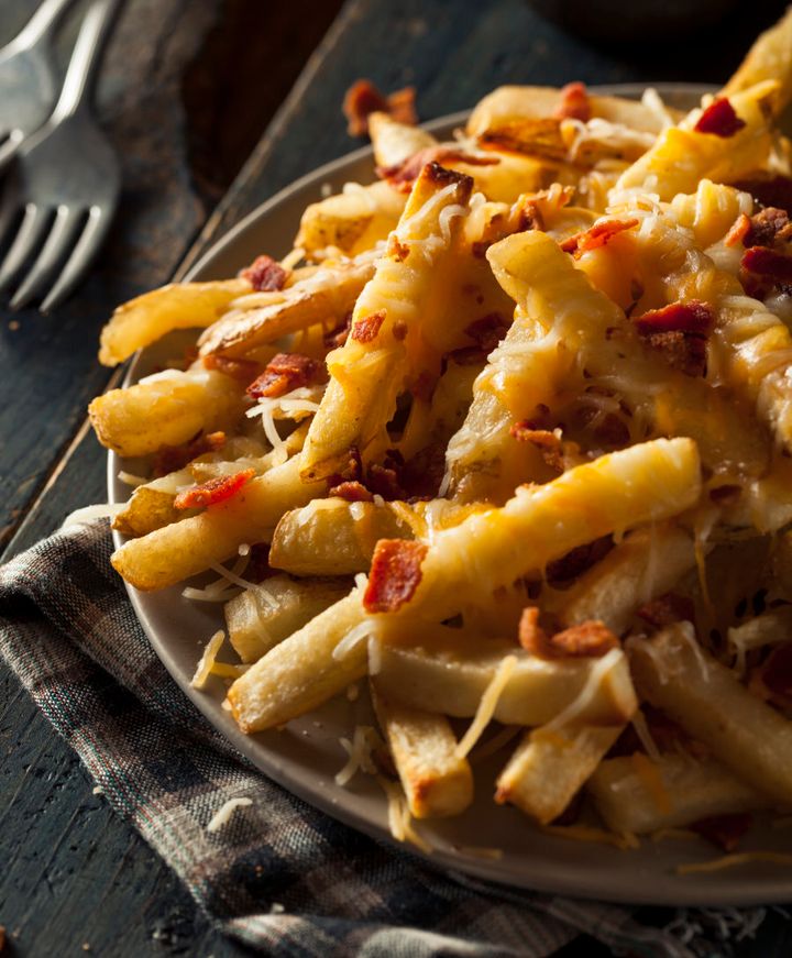 Homemade salty cheese French fries with bacon.