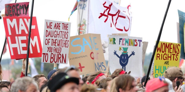 Crowds hold signs as they are excited by Jeremy Corbyn as he speaks on the Pyramid stage at Glastonbury Festival last week