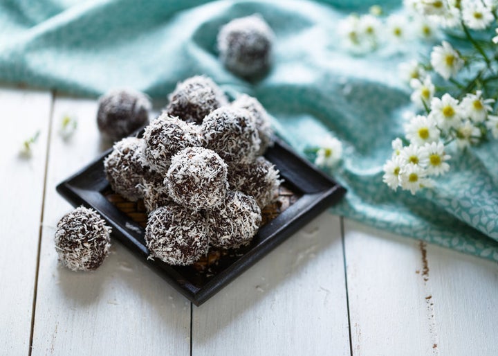 Process some medjool dates with nuts and cacao, and roll in coconut for quick, easy energy balls.