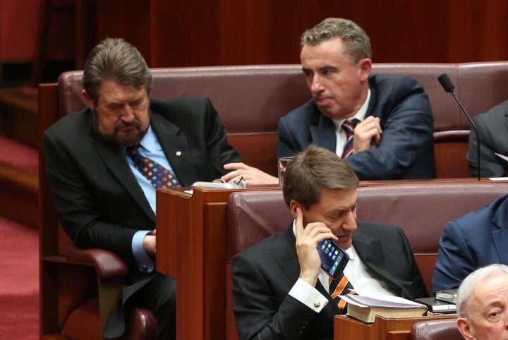 Wake Up! Senator Derryn Hinch is nudged by Kevin Hogan during the opening of the 45th Parliament