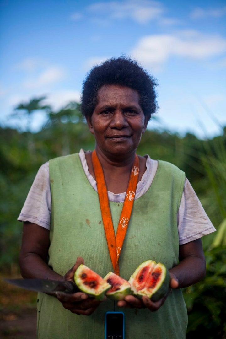 Lucy cracks open a stunted watermelon. There isn't enough water to grow their usual crops.