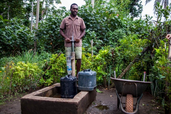 A Taloa man fetches washing water for his family. The community currently has to use hand pumps from a deep bore. They hope that one day they will have a solar powered pump system.