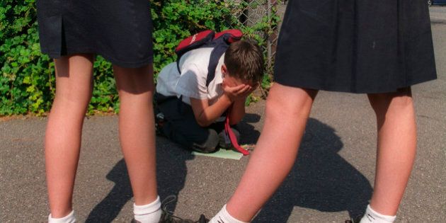 Girls bullying smaller boy at school modelled. (Photo by: Photofusion/UIG via Getty Images)