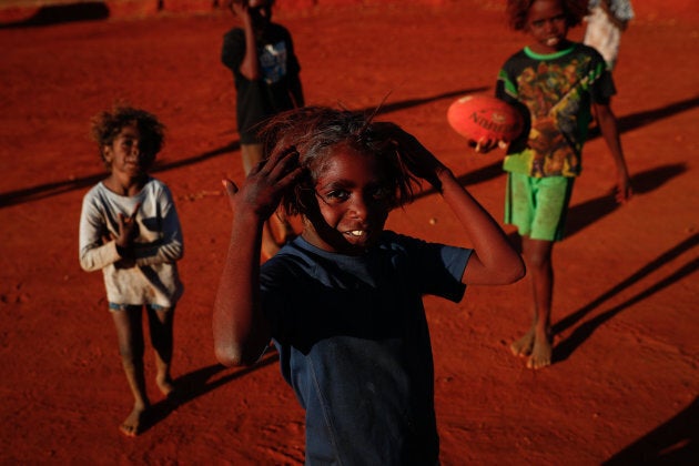 Children playing footy during the closing ceremony in the Mutitjulu community of the First Nations National Convention held in Uluru in May