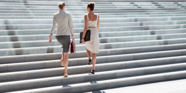 Businesswomen walking up steps outdoors