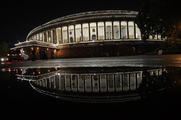 View of the Indian Parliament illuminated prior to a special session for the implementation of the new Goods and Services Tax (GST) regime in New Delhi.
