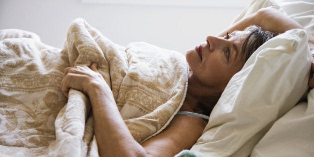 Woman lying in bed, trying to sleep