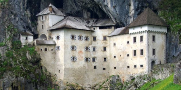 Predjama Castle in Slovenia is characterized by being built into the mouth of a cave, as you can see in the picture.It is also surrounded by green meadows, which make it unique.