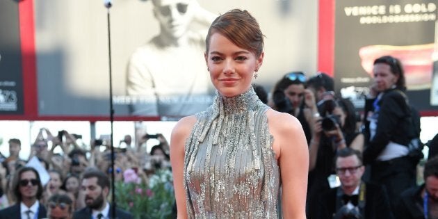 US actress Emma Stone poses on the red carpet as she arrives for the screening of the movie 'La La Land' at the opening ceremony of the 73rd Venice Film Festival, on August 31, 2016 at Venice Lido. / AFP / TIZIANA FABI (Photo credit should read TIZIANA FABI/AFP/Getty Images)