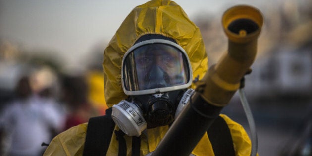 A worker fumigates the Sambadrome ahead of Carnival celebrations in Rio de Janiero, Brazil, on Tuesday, Jan. 26, 2016. The operation is part of the Health Ministry's efforts to eradicate the Aedes aegypti mosquito, which is thought to spread the Zika virus being blamed for causing birth defects. Photographer: Dado Galdieri/Bloomberg via Getty Images