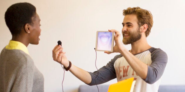 Creative businessman holding digital tablet and headphone