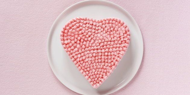 Pink heart shaped cake decorated whipped cream,aerial view.