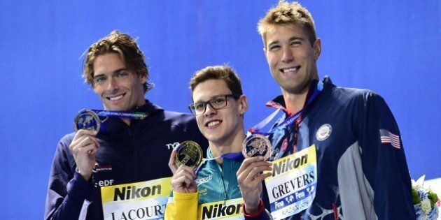 Australia's Mitchell Larkin (C), gold, France's Camille Lacourt (L), silver, and USA's Matt Grevers pose during the podium ceremony of the men's 100m backstroke swimming event at the 2015 FINA World Championships in Kazan on August 4, 2015. AFP PHOTO / MARTIN BUREAU (Photo credit should read MARTIN BUREAU/AFP/Getty Images)