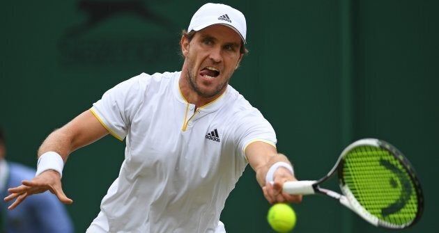 Germany's Mischa Zverev returns against Australia's Bernard Tomic.